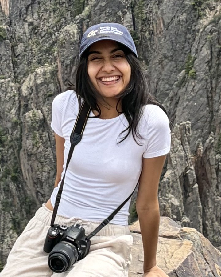 Shreya Jha smiling at the edge of a canyon